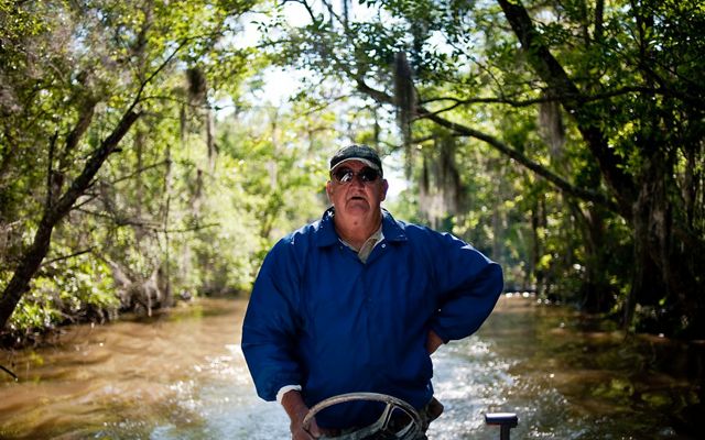 James Holland, a riverkeeper and retired crabber, drives a motorboat.