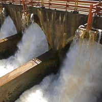 Water rushing through the gates of a dam.