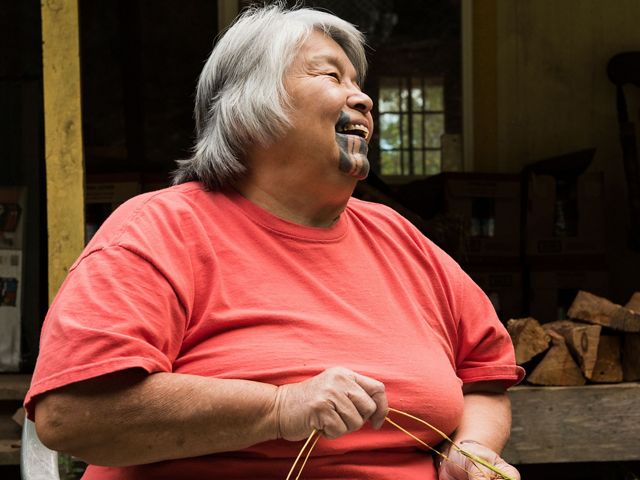 A Yurok tribal elder demonstrates basket weaving