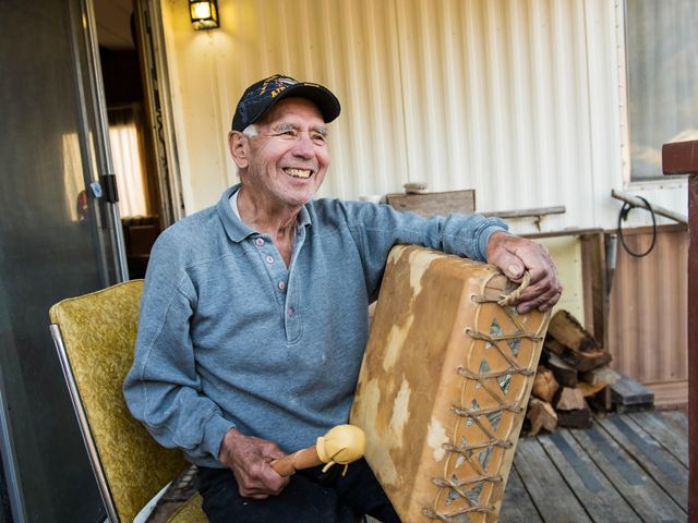 A Yurok tribe member plays an elk hide drum