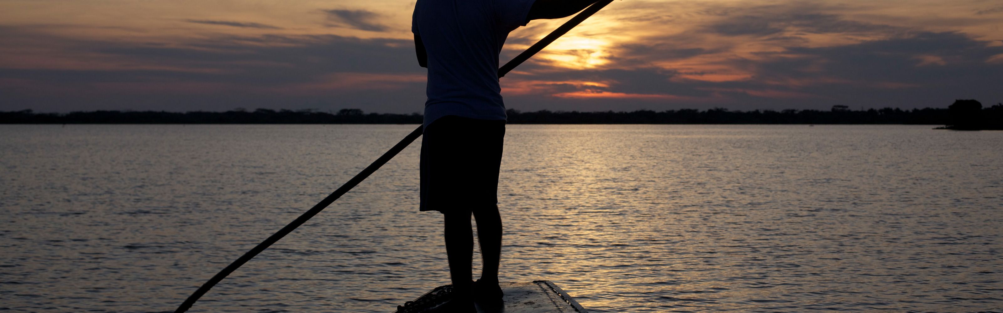 Fisherman sailing along the Magdalena River