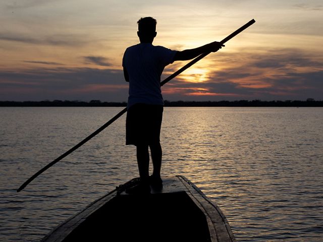 Fisherman sailing along the Magdalena River