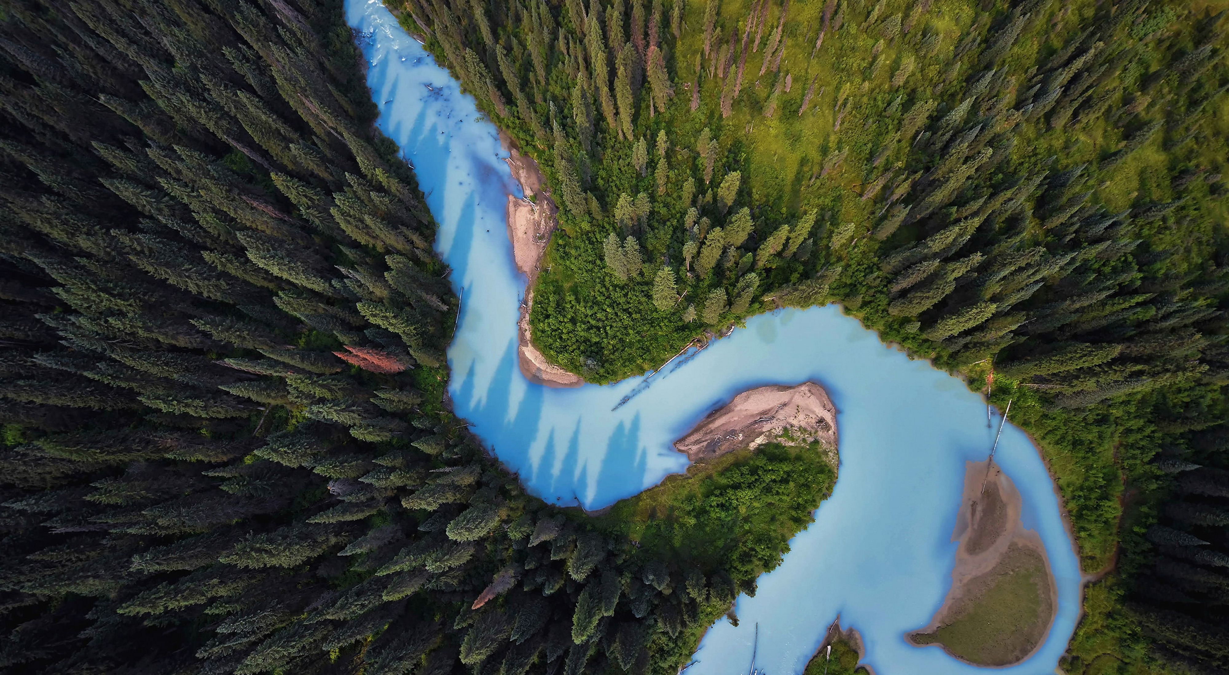 Aerial view of the Holmes River in British Columbia, Canada, surrounded by dense forests.