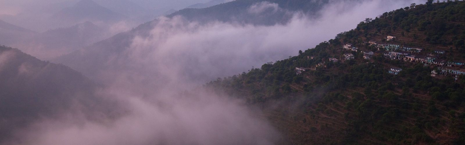 The morning clouds and fog lift off the small towns in the lower Himalaya mountains.