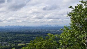 View across a wide landscape of NYC as seen from the summit of High Mountain.