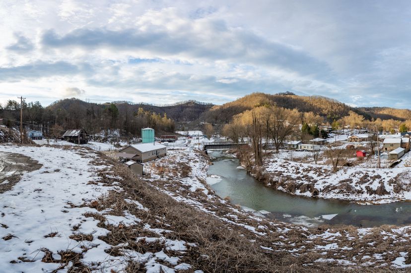 Panoramic photo of Letcher County Kentucky with houses in the bend of the creek. 