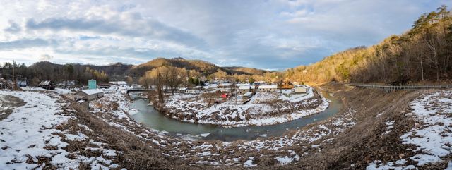 Panoramic photo of Letcher County Kentucky with houses in the bend of the creek. 