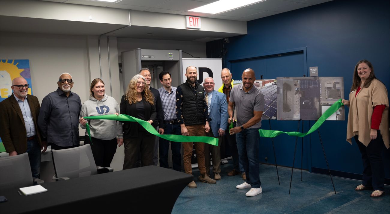 Urban Dreams Executive Director cuts a ribbon