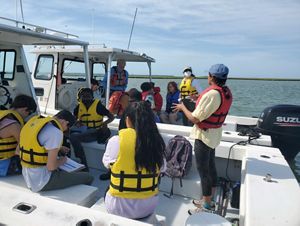 Intern guiding a boat tour.