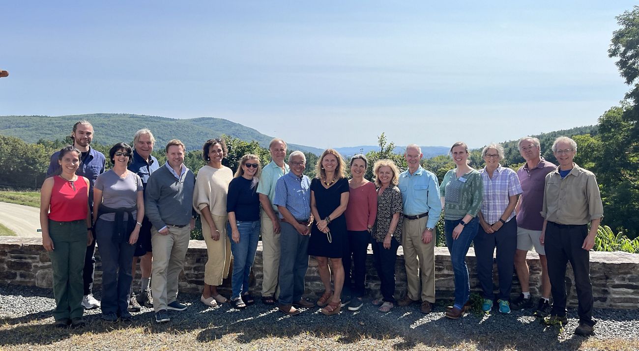 Members of the TNC Vermont board of trustees stand outdoors and smile for a group portrait.