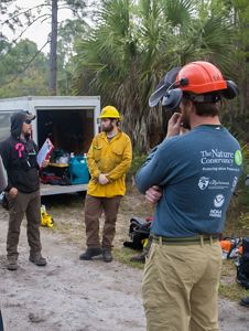 Fire crew members listen to a briefing.