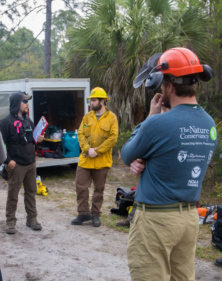Fire crew members listen to a briefing.
