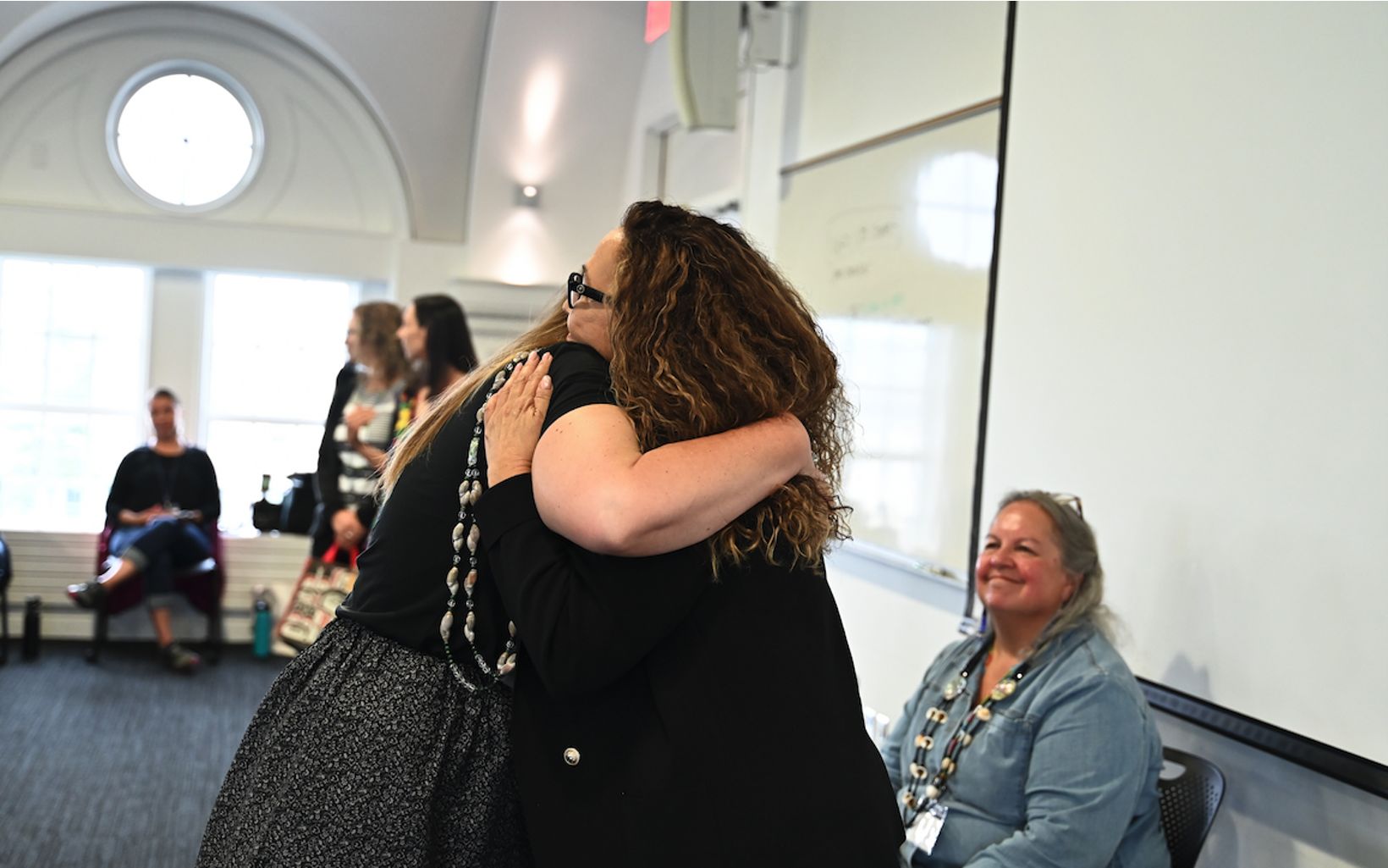 Loving Embrace Brie Fraley thanking Dawn Martin-Hill after a compelling panel full of calls to action. 