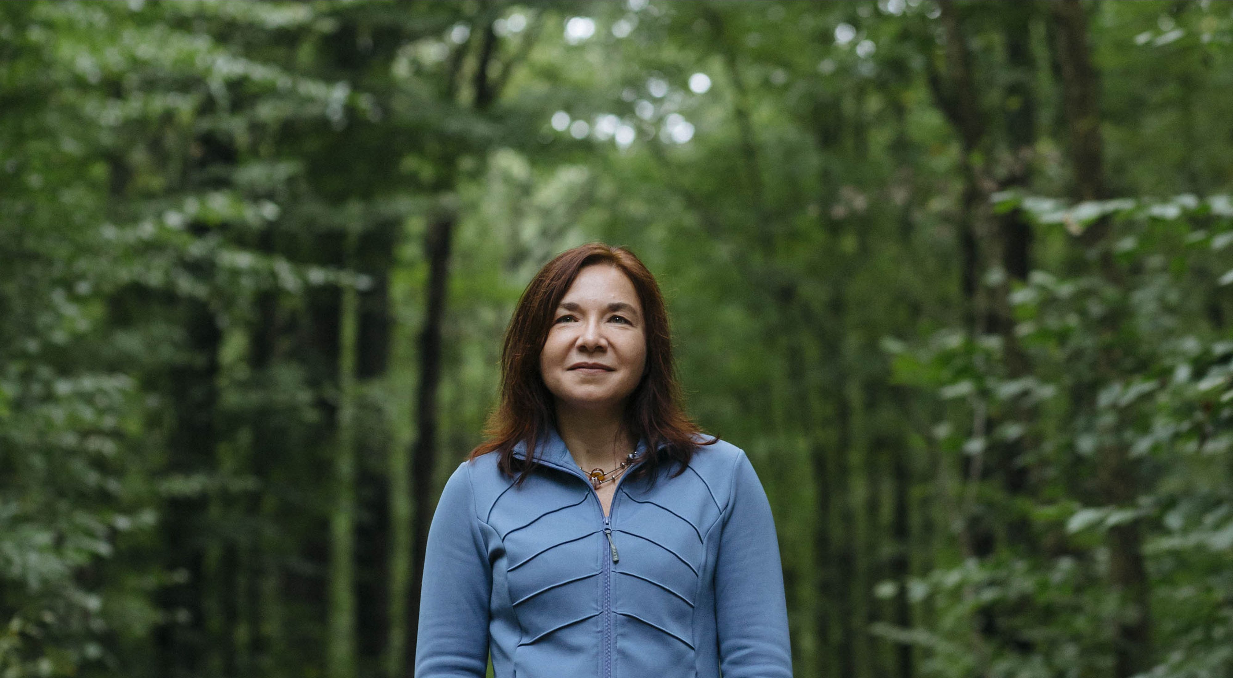 Katharine Hayhoe standing in a forest