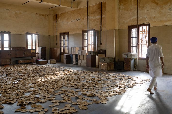 Leftover roti breads are spread on the floor of the Golden Temple.