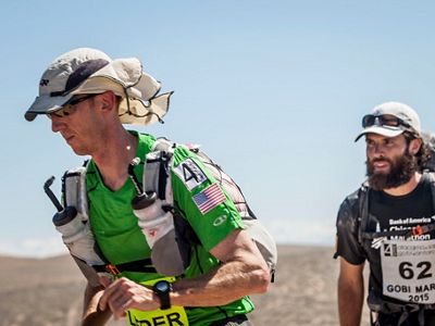 Kyle (left) runs in the Gobi March race as part of the 4 Deserts Ultramarathon series.