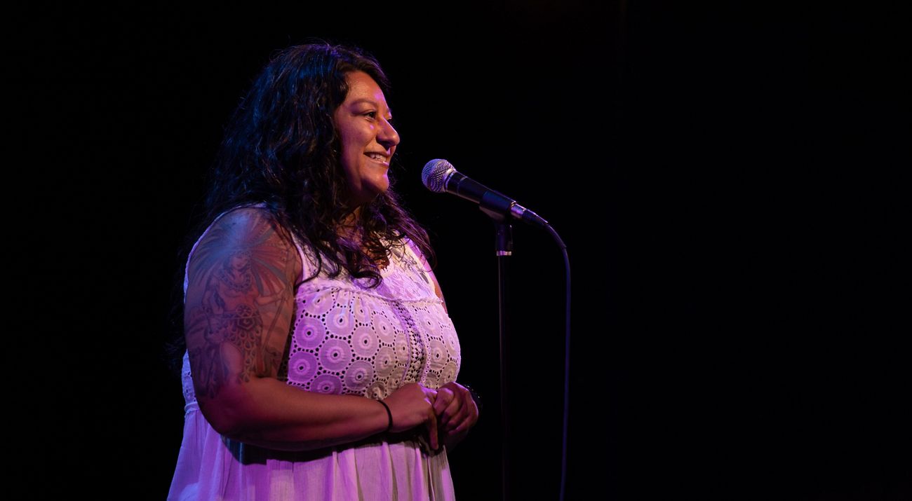 Lylianna Allala speaking into a microphone.