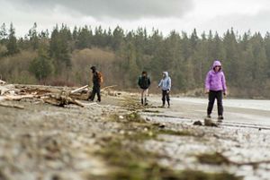 A group of people gather on sand. 