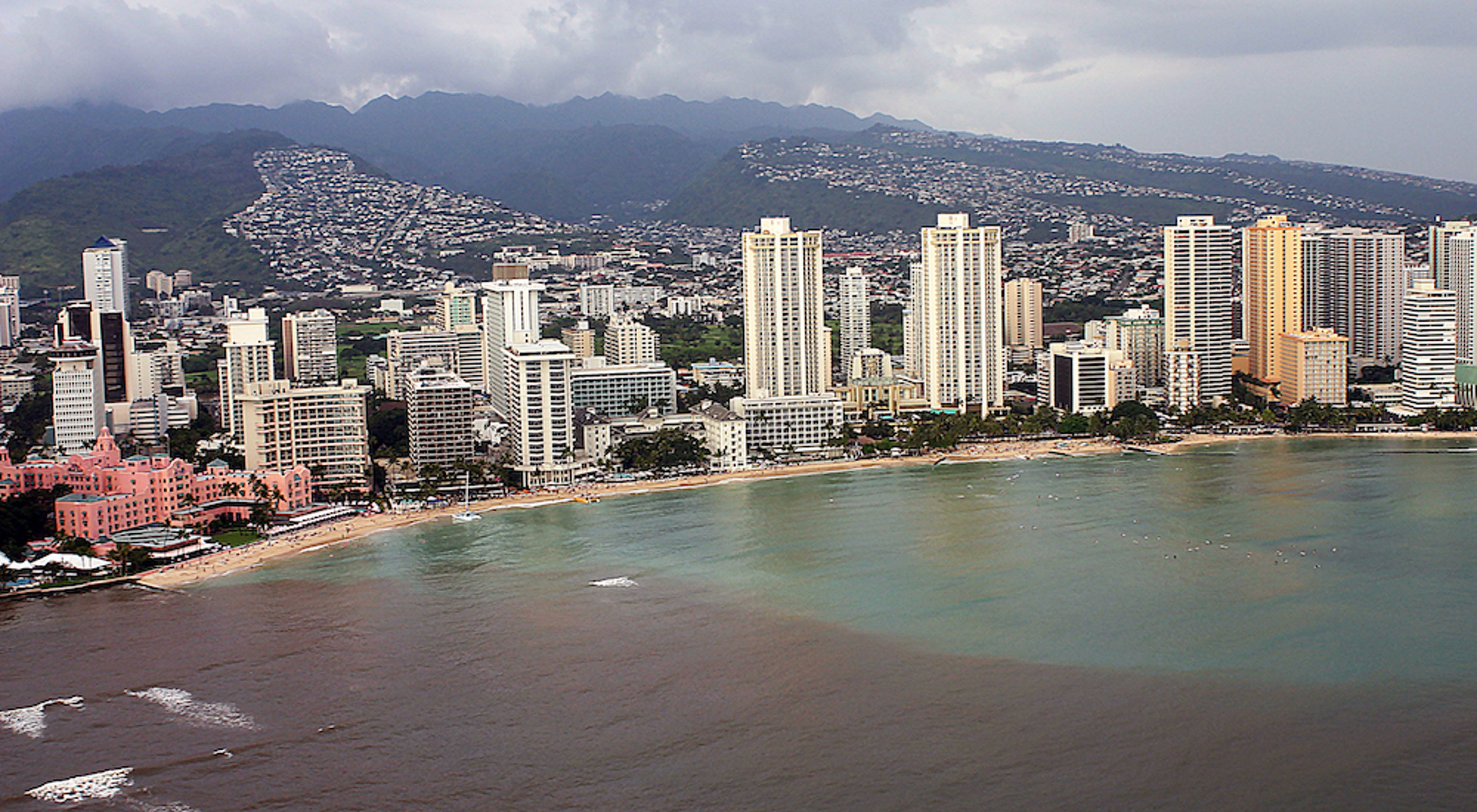 Cityscape along Waikiki beach with polluted water in the foreground