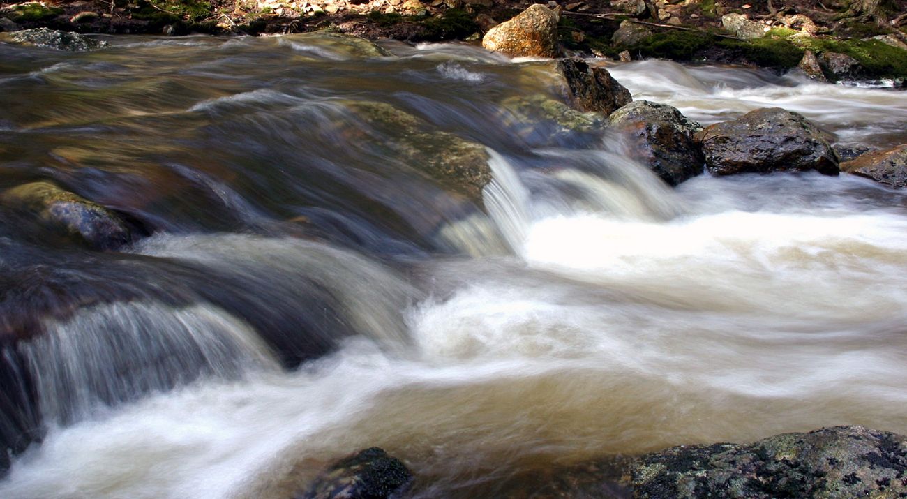 Water rushing over rocks in a river.