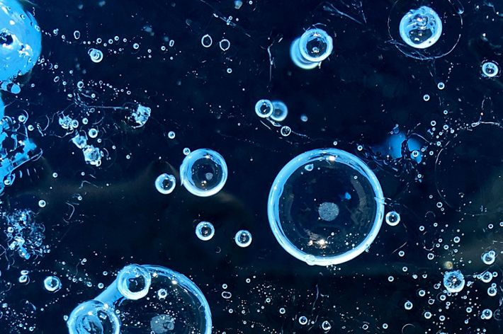 Frozen air bubbles on the top layer of ice on a glacier.