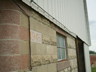 Closeup of a white barn with a marking that reads "1946".