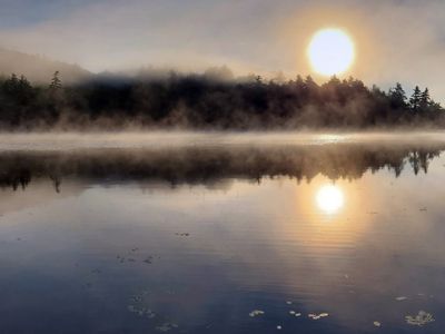 Mist over a lake at sunrise.