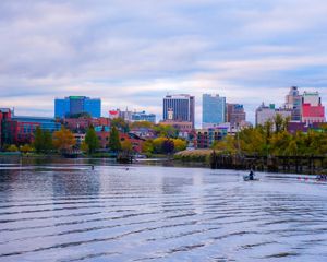 A view of a city skyline in front of a body of water.