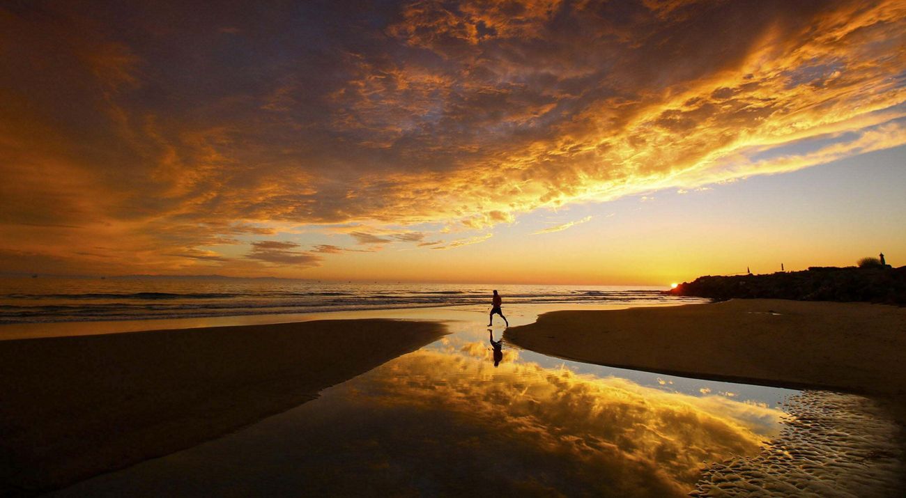 Person on the beach at sunset.