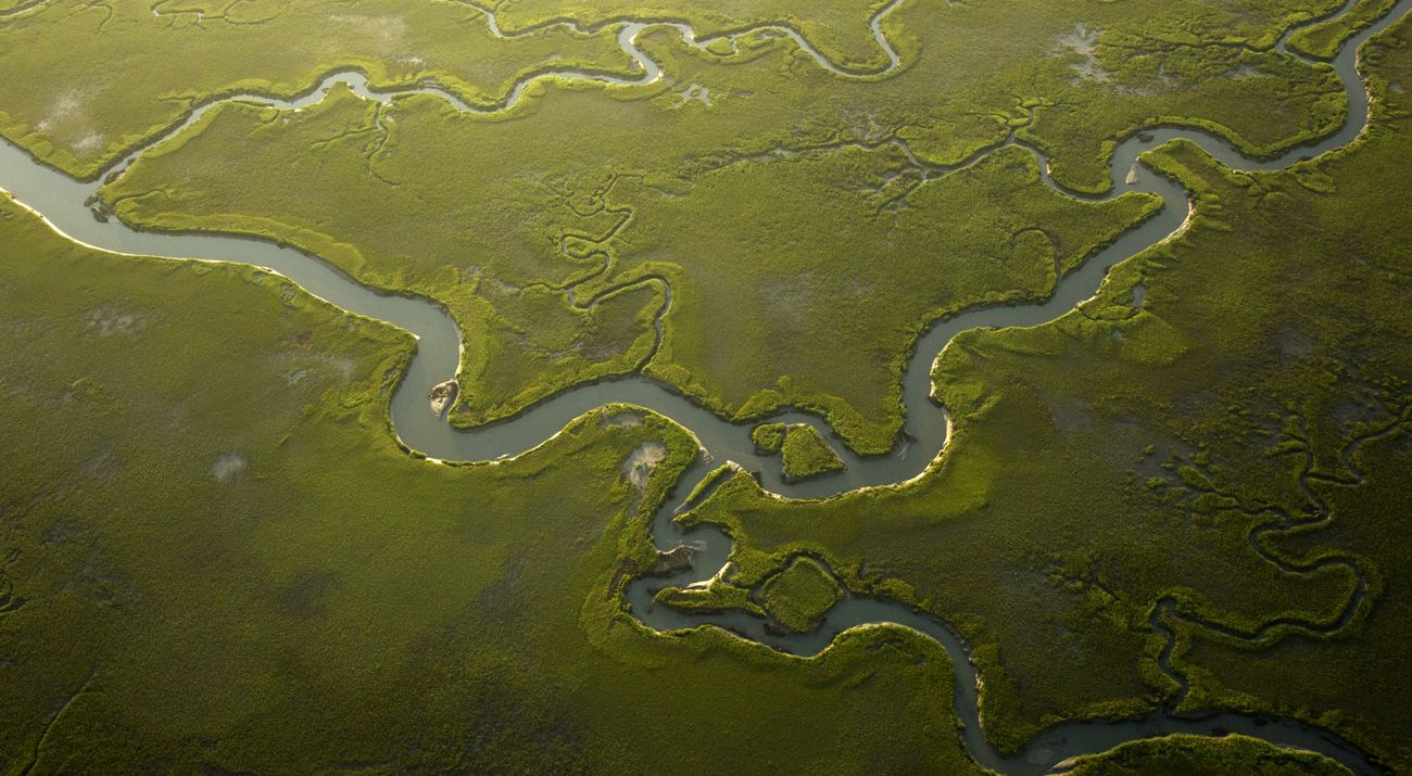 Aerial of river with green around.