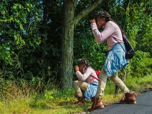 Two people hiking with binoculars.