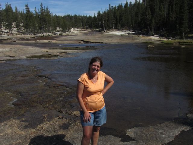Francie Mitchell standing in front of a wide river.