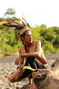 Two smiling men arm-in-arms, in a small village.