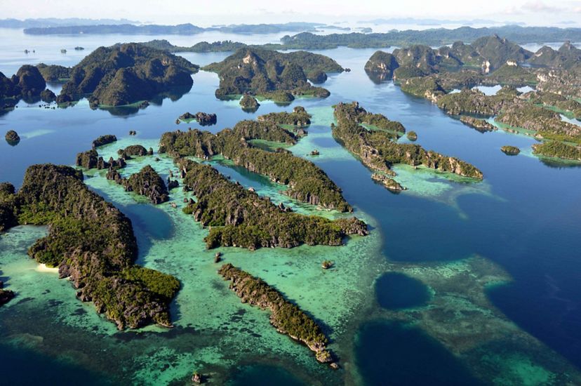 an aerial image of dozens of jagged, green islands in Indonesia.