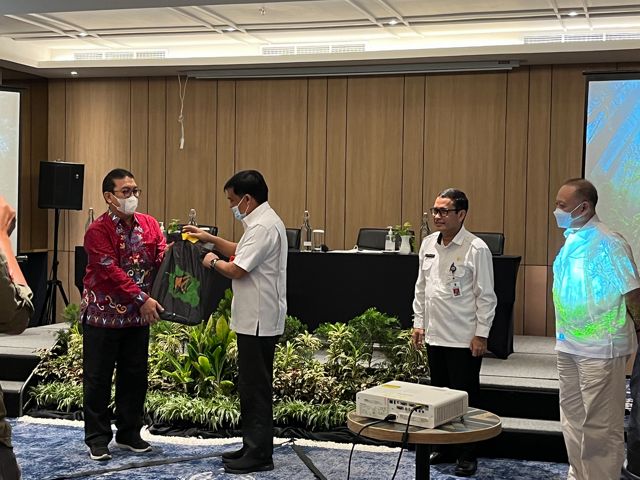 Penyerahan cindera mata dari Ketua Forum KEE Wehea Kelay EA Rafiddin Rizal kepada Sekretaris Dinas Lingkungan Hidup (DLH) Provinsi Kalimantan Tengah Mathius Hosang.