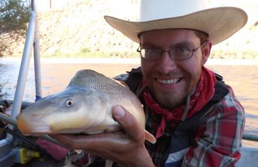 Zach Ahrens holding a razorback sucker.
