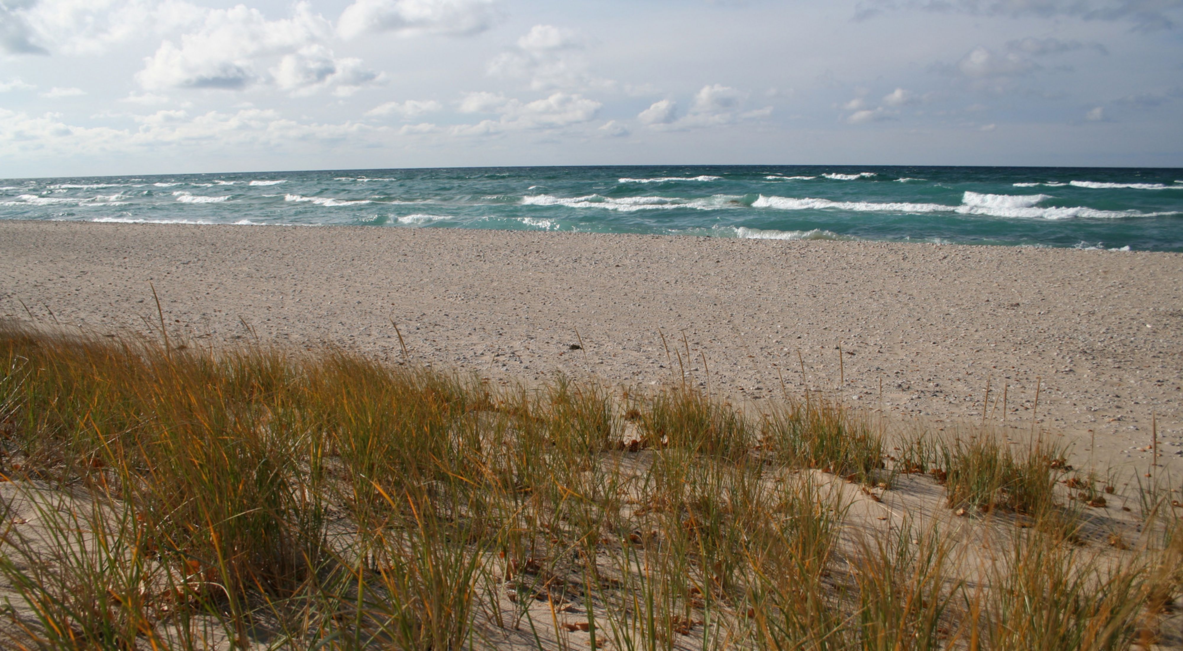 Waves roll onto the sandy shore of Zetterberg Preserve at Point Betsie. 